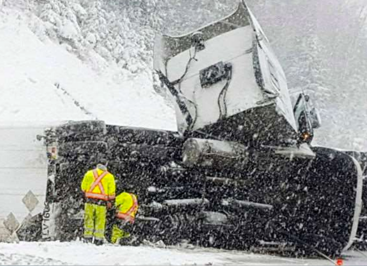 Photo of jack-knifed truck in a snowstorm on the TransCanada Highway west of Thunder Bay