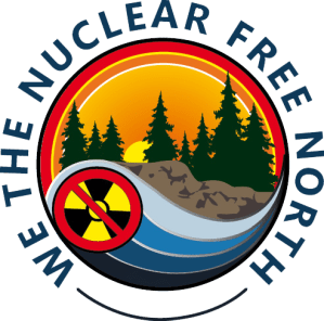We the Nuclear Free North logo - circle with "no radioactivity" symbol, water, rocks, trees and sun