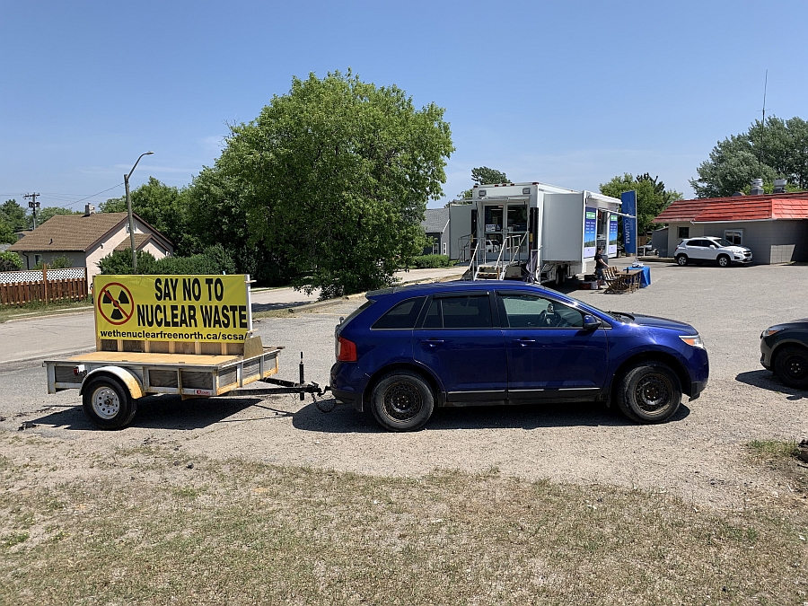 Photo of car with trailer, carrying sign that says "Say No to Nuclear Waste - wethenuclearfreenorth.ca/scsa/